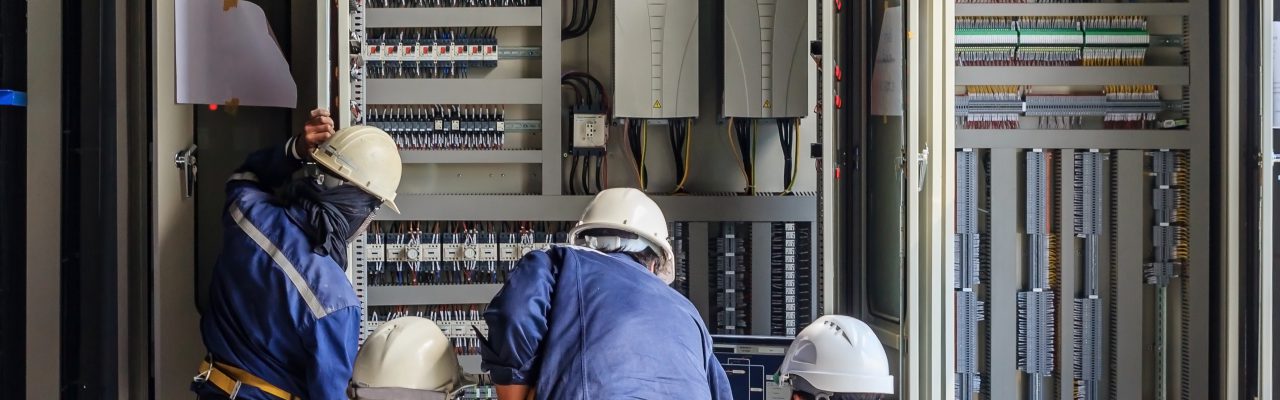 1084 Engineer working on checking and maintenance equipment at wiring on PLC cabinet, Engineer checking status step up transformer